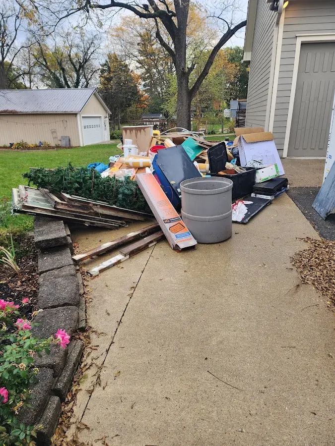 Dumpster being loaded with debris for Estate Cleanout Dumpster Rental in Arcola